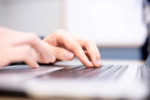 Fingers typing on a keyboard