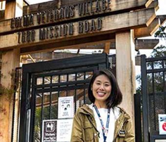 Postdoc Anna Oh outside of the Colma Veterans Village