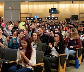 Audience for 2019 Postdoc Slam cheers finalists on.