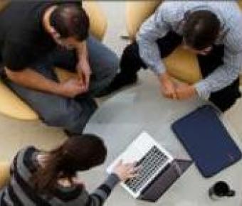 Picture of 3 people sitting around coffee table talking